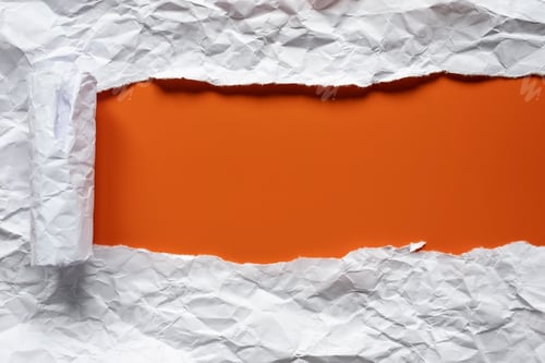 Preview: Torn sheet of white crumpled paper, folded into a roll, on red background with place for inscription