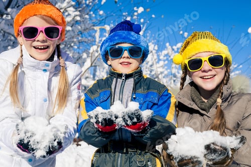 Preview: Happy little children playing in winter snow day.