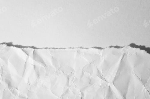 Preview: Torn, crumpled sheet of paper on a white background. Top view, macro photo