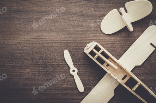 Preview: handmade airplane on brown wooden table