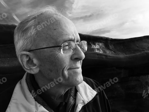 Preview: A happy man on the coast by the cliffs, looking out toward the Pacific Ocean