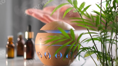 Preview: Modern aroma oil diffuser on the white table. Spa concept for body