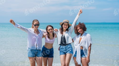 Preview: Happy children laughing and enjoying at beach. Teenage playing with friends at the sea.