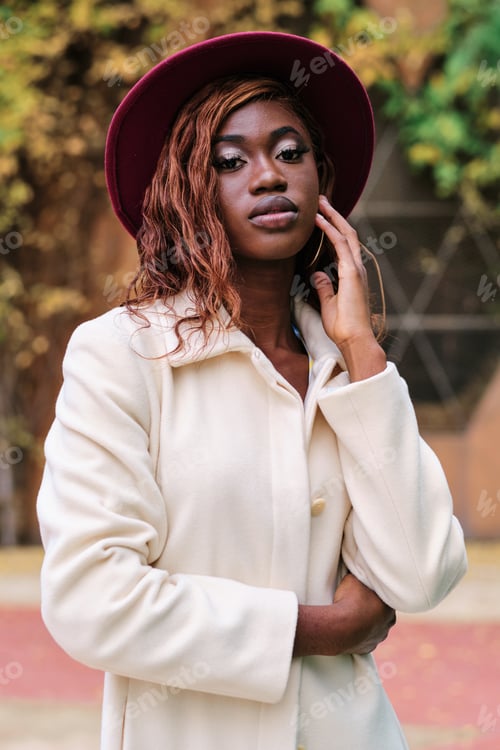 Preview: Stylish and confident woman posing standing outdoors.
