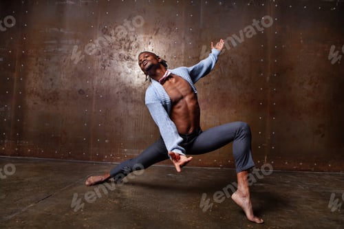 Preview: Attractive African American man showcases flexibility, leg splits and dancing. Man stretching