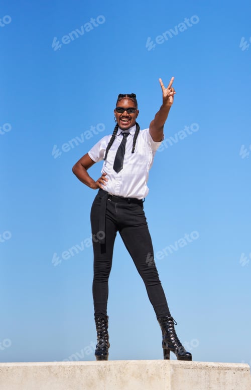 Preview: Gay man in white shirt poses for a photo with his hands victory sign