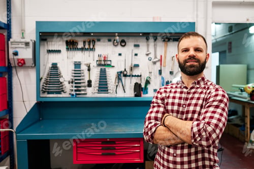 Preview: an adult man in front of his workshop with many tools behind him