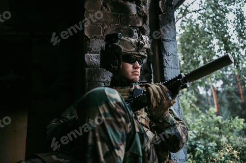 Preview: Man in Camouflage Gear with a Rifle