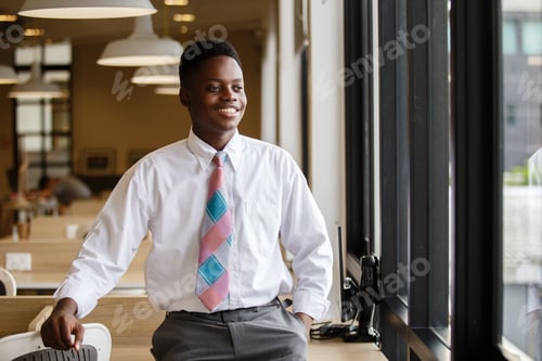 Preview: portrait young businessman handsome African American black skin smiling standing at business office.