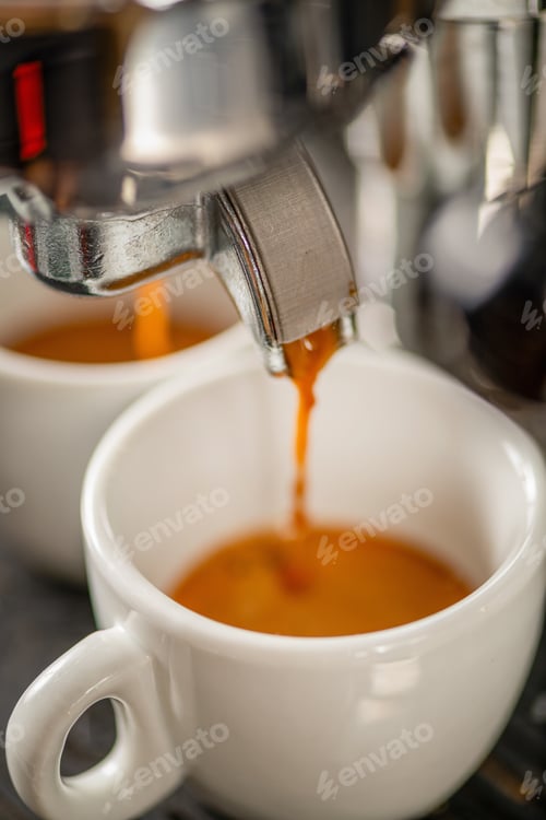 Preview: Espresso pouring into cup from machine in coffee shop.