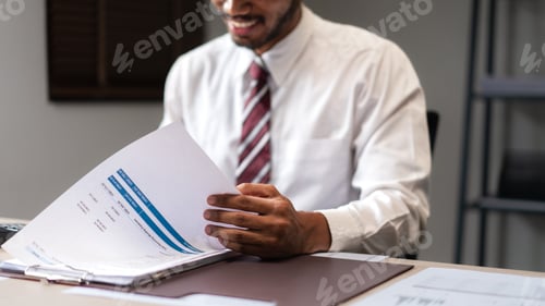 Preview: Businessman checking marketing document and analyzing strategy of new startup business project
