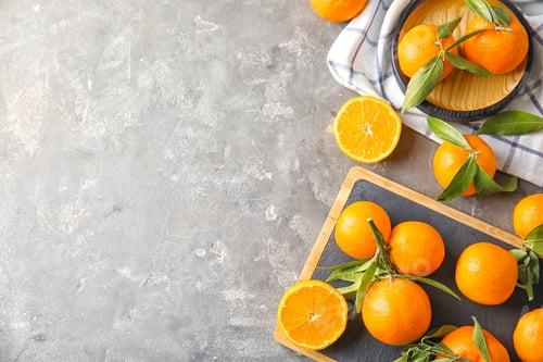 Preview: Flat lay composition with ripe tangerines on grey background. Space for text