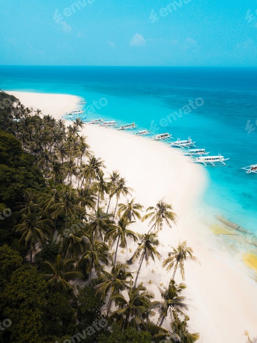 Preview: Sandy beach with boats on the crystal clear ocean