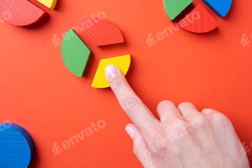 Preview: hands working with colorful wooden pie chart pieces