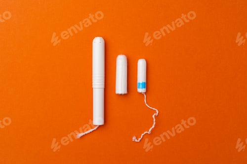 Preview: Medical female tampons on orange background top view