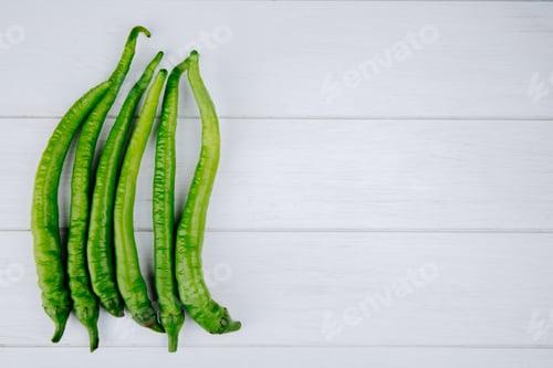 Preview: top view of green chili peppers isolated on white background with copy space