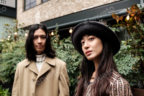 Preview: Fashionable asian couple posing together outdoors