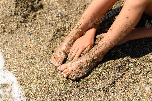 Preview: children's feet in the sea sand and water
