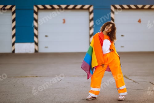 Preview: African lesbian woman holding LGBT rainbow flag. Concept of happiness, love for same-sex couples.