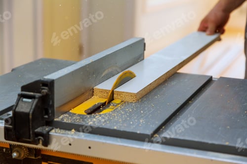 Preview: Contractor man working Using Circular Saw Cutting New wood board for Renovation.