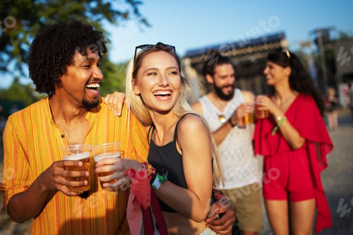 Preview: Happy friends laughing and having fun outdoors