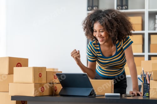 Preview: Pretty young african american woman start up freelance business people is working at warehouse
