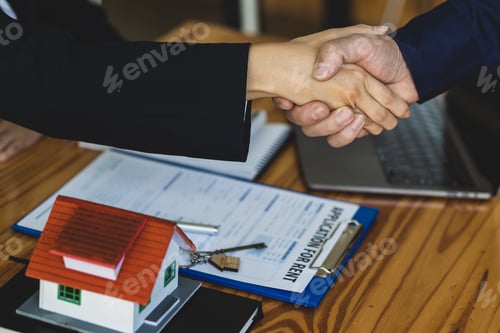 Preview: Handshake after reaching a real estate deal. Signing a house rental agreement.