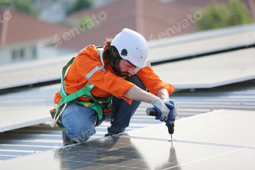 Preview: Workers Installing Solar Panels on warehouse Roof.