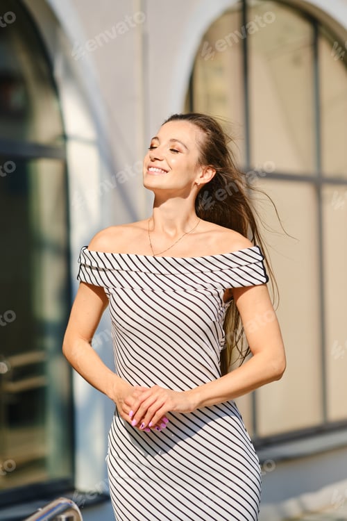 Preview: Portrait of young woman in striped dress