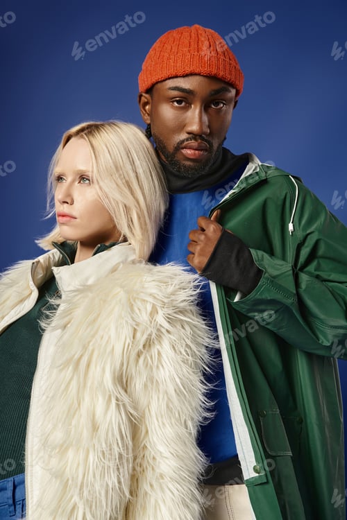 Preview: interracial couple, beautiful woman in white faux fur jacket and african american man on blue