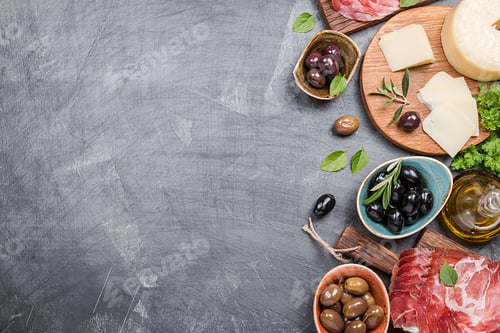 Delicious Olives and Cheese on a Slate Background
