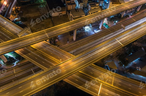 Preview: Top view of massive expressway at night with light of cars, transportation industrial concept