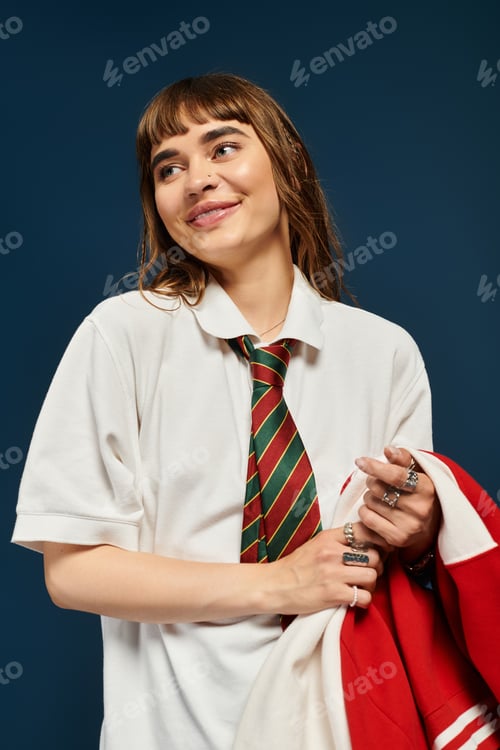 Preview: Smiling student exudes confidence in casual school attire with bright background
