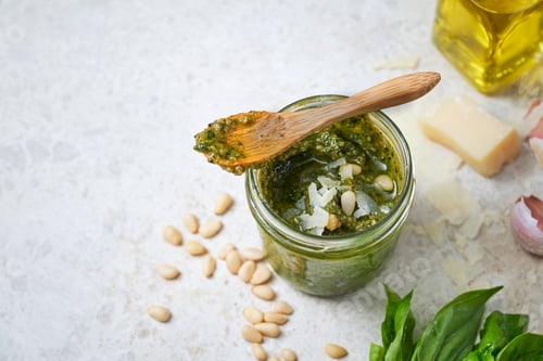 Preview: Basil pesto sauce and fresh ingredients on light marbre background, Copy Space, Selective focus.