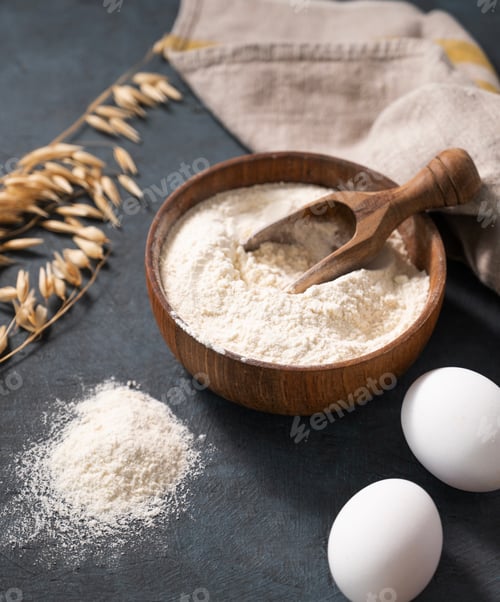 Preview: Oatmeal in a wooden bowl with a scoop on a dark blue background with eggs and dry branches oats.