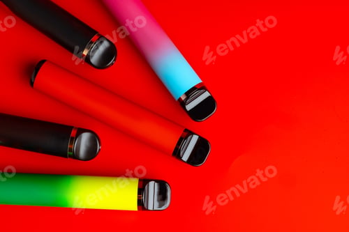 Preview: Colorful disposable electronic cigarettes on red background