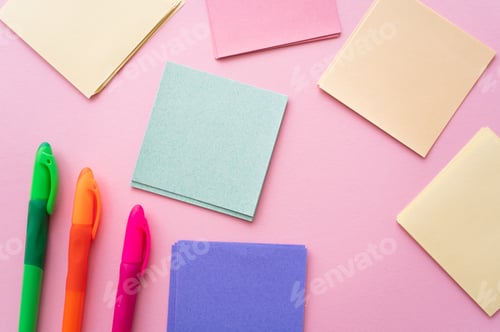 Preview: top view of colorful pens near blank paper notes on pink