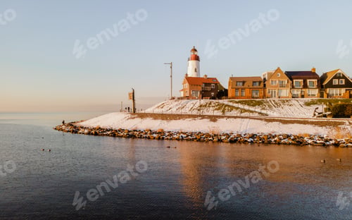 Preview: Lighthouse of Urk with snow landscape during winter in the Netherlands