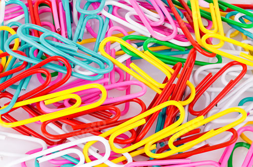 Preview: Stationery paper clips, multicolored close-up as a background. Stationery concept.