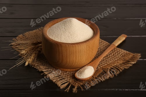Preview: Fresh semolina and spikelets on black wooden table