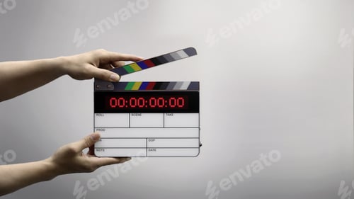 Preview: Digital film slate for filmmaker in set. Hand hitting timecode clapperboard or movie slate for Video Production. Digi number clapper board or film slates action on set. Tools in modern cinema industry