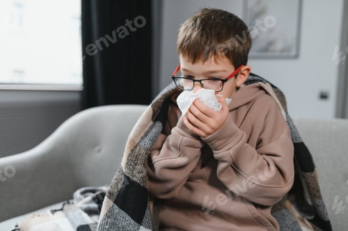Preview: little child boy is sick. A thick scarf is wrapped around her neck. Treatment of colds and flu.