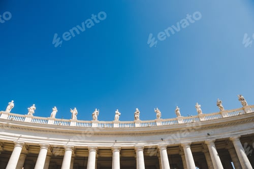 Preview: bottom view of statues at St Peters Square on blue sky in Vatican, Italy