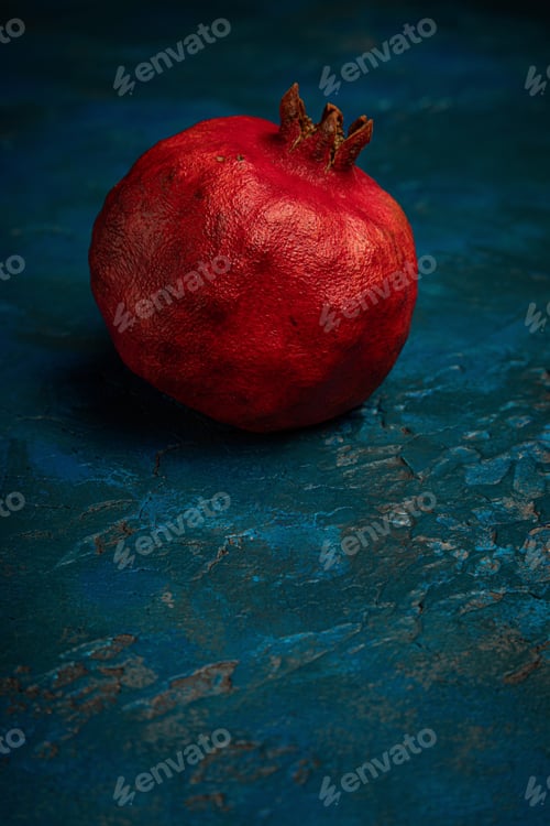 Preview: red pomegranate on a blue background