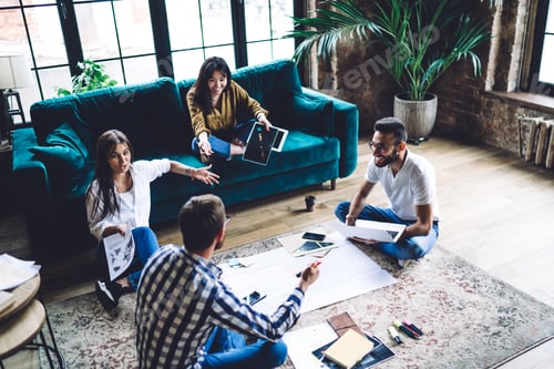 Preview: Group of cheerful coworkers talking in office