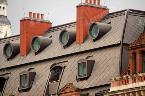 Preview: Unique architectural design with circular windows and chimneys.