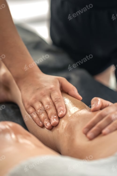 Preview: Smooth oil strokes on shin during massage. Leg massage.