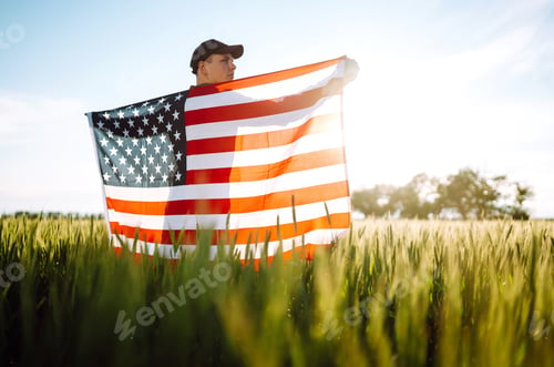Preview: Man hold waving american USA flag. Patriot raise national american flag. Independence Day, 4th July.
