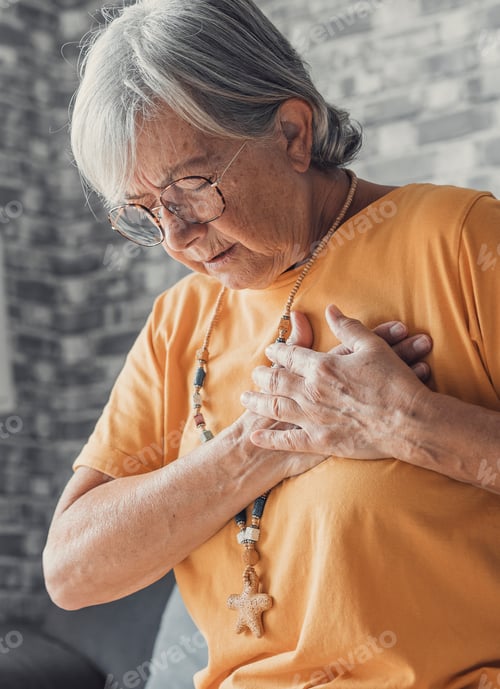 Preview: Upset stressed mature middle aged woman feeling pain ache touching chest having heart attack