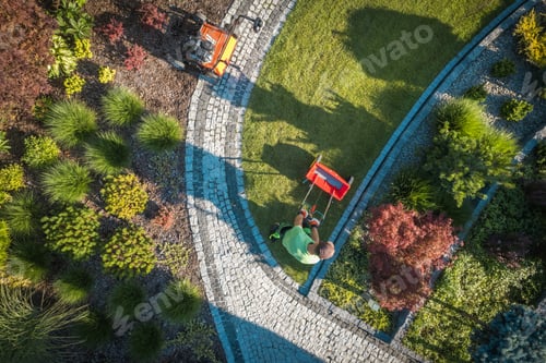 Preview: Aerial View of Man Spreading Fertilizer on a Lawn